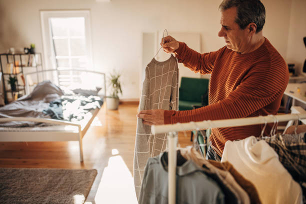 istock A man chooses clothes at home 1360942052