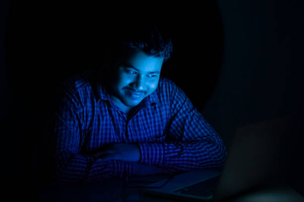 istock young man watching movie at night 1360946112