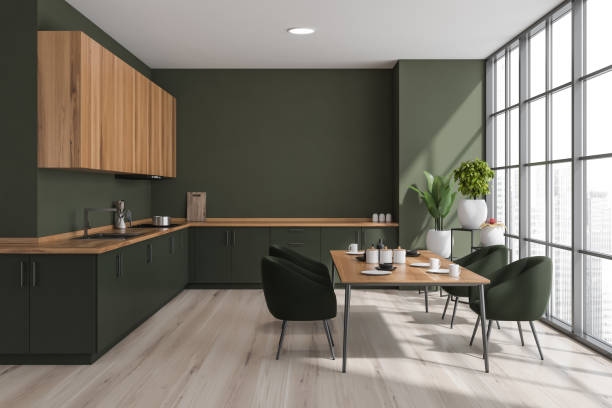 istock Green kitchen interior with table and chairs on parquet floor near window 1360951625