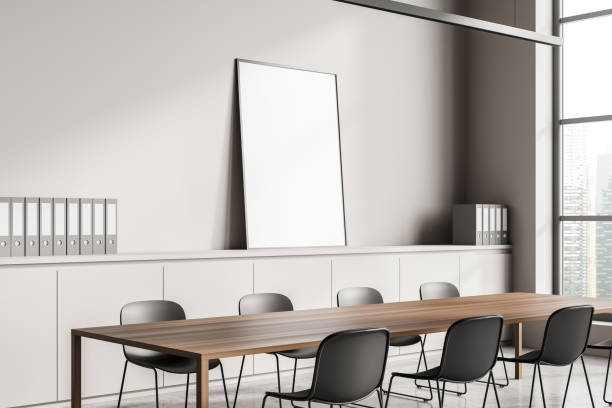 istock Minimalist conference interior behind near windows, drawer and mockup poster 1360952152