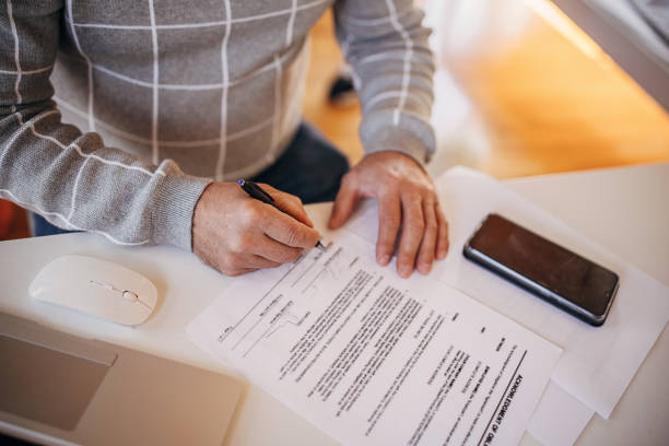 istock Signing a paper document in the office 1360954859