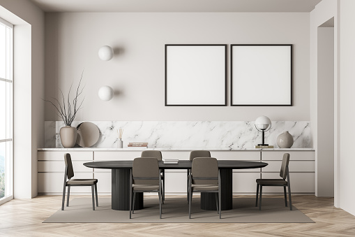 Two square canvases in dining room interior with oval black table, chairs, extra large sideboard with marble detail, lights and parquet floor. Concept of modern house design. Mock up. 3d rendering