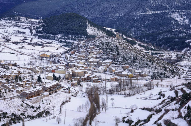 Snowy village of Gósol in winter, seen from the Coll de Josa (Berguedà, Catalonia, Spain, Pyrenees) stock photo