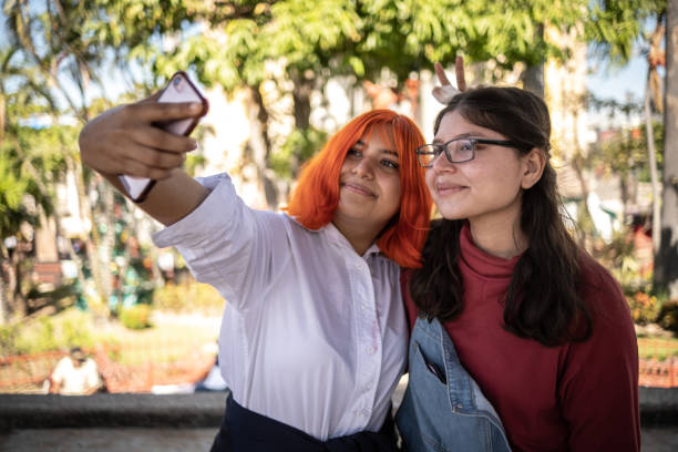 istock Friends taking a selfie using mobile phone outdoors 1360965443