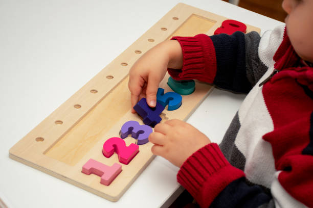 istock Baby toddler early development. Wooden stack and count rainbow colors learning game. Child learn colors and numbers 1360982060