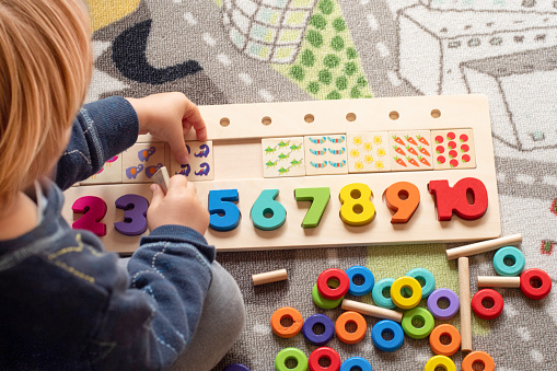 Baby toddler early development. Wooden stack and count rainbow colored learning game. Child learn colors and numbers