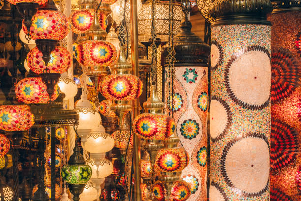 Traditional turkish or moroccan light mosaic lamp. Colorful stained glass lamp against defocused souvenir shop background with copy space. Popular souvenir and ideas for present Traditional turkish or moroccan light mosaic lamp. Colorful stained glass lamp against defocused souvenir shop background with copy space. Popular souvenir. Selective focus grand bazaar istanbul stock pictures, royalty-free photos & images