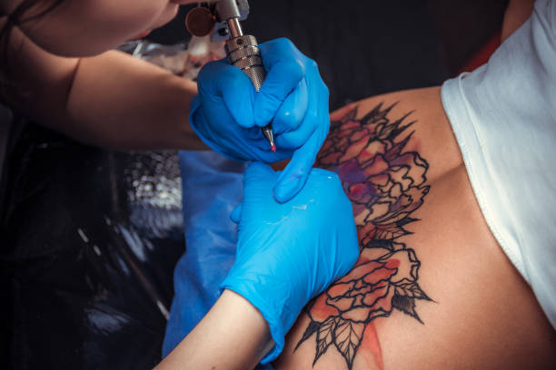 istock Professional tattooer makes cool tattoo in tattoo parlor 1361010861