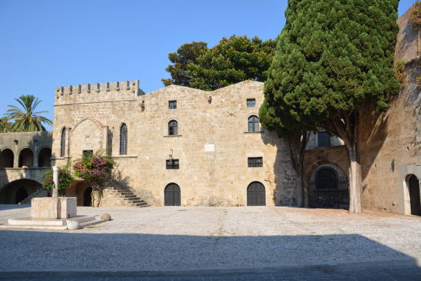 istock ancient brick buildings with square and green trees on blue sky background 1361012817