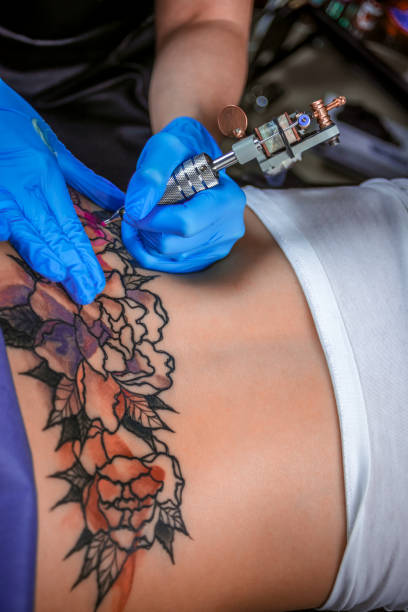 istock Tattoo specialist at work in tattoo studio 1361013145