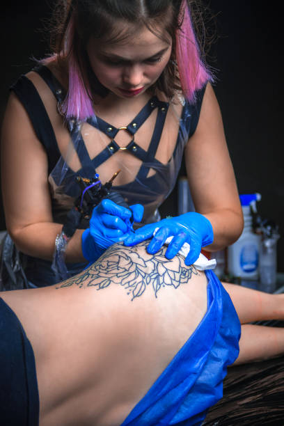 istock Tattooist doing tattoo in tattoo studio 1361017985