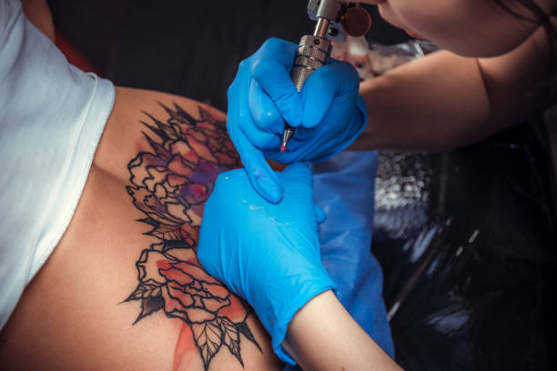 istock Professional tattooer makes cool tattoo in tattoo parlor 1361018007