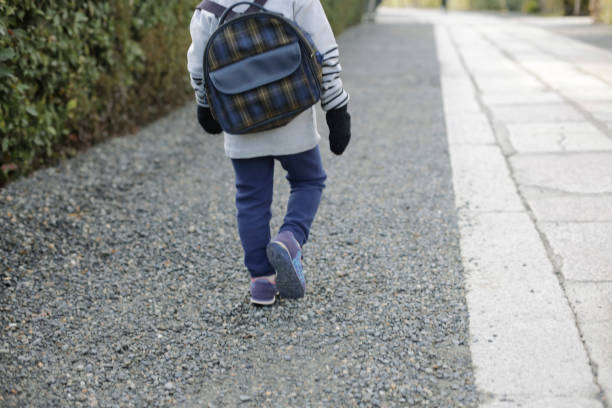 istock Boy walking to school on a winter day. 1361031953