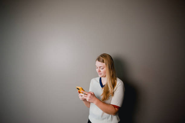 istock Blond Woman Texting on her Smart Phone 1361038485