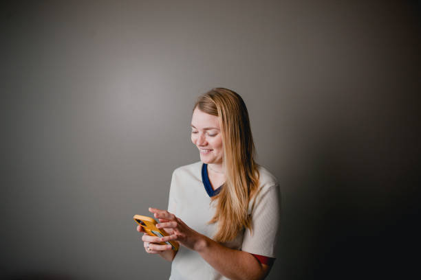 istock Blond Woman Texting on her Smart Phone 1361038499