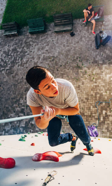 istock Young climber descending on rope of artificial wall 1361049006