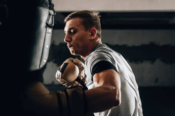istock Hispanic MMA Fighter practicing some kicks with a punching bag 1361049524