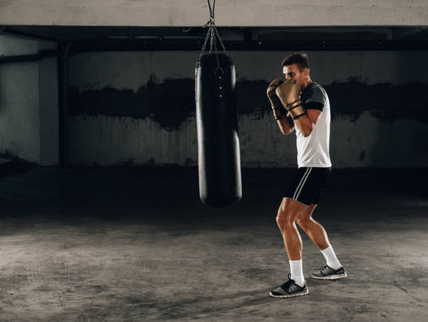 istock Boxer and athlete training and practicing kicks in the gym 1361049531