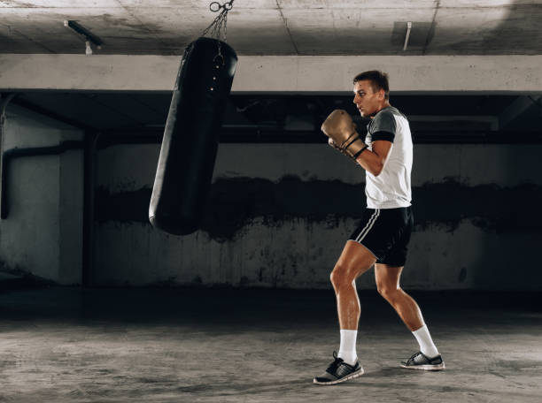 istock Horizontal view of handsome sporty man training boxing 1361049533
