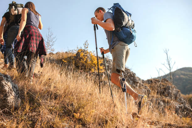 istock Disabled young men going mountain climbing with his friends 1361050474
