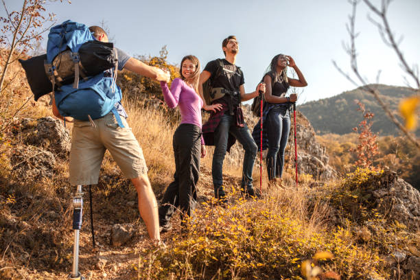 Disabled young men going mountain climbing with his friends Disabled young men going mountain climbing with his friends people laughing hard stock pictures, royalty-free photos & images