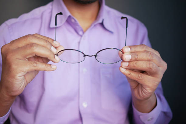 istock Close up of man hand holding old eyeglass 1361063949