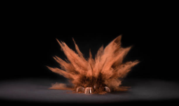 istock Violent cocoa explosion with bonbons on a dark background. Selective focus 1361074868