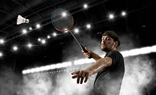 Man badminton player in action during game