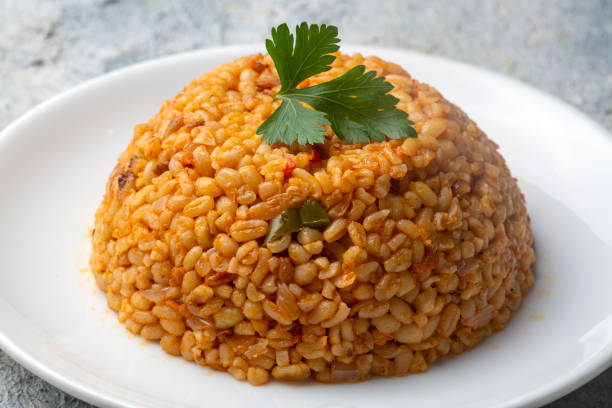 istock Traditional turkish bulgur pilaf with tomato sause in plate (Turkish name; meyhane pilavi) 1361081002