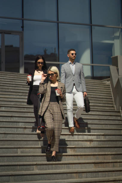 istock Three business people walking and talking on the stairs 1361082756