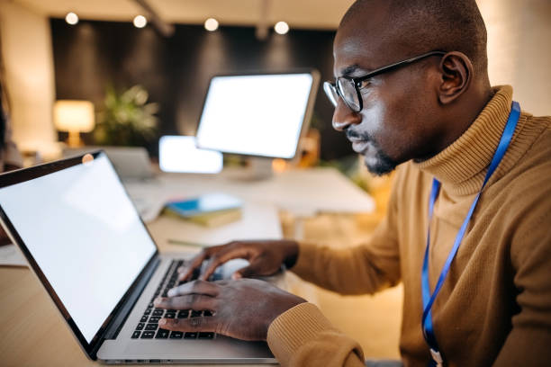 istock Young black entrepreneur working with laptop, office interior 1361084751