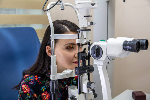 Patient on diagnostic of vision, oculist cabinet. Optician measuring a woman's eyesight. Young woman visiting ophthalmologist in clinic. Optometrist checking vision of young beautiful woman. Patient on diagnostic of vision, oculist cabinet. Optician measuring a woman's eyesight. Young woman visiting ophthalmologist in clinic. Optometrist checking vision of young beautiful woman. sailing dinghy stock pictures, royalty-free photos & images