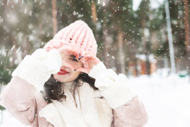 istock Cool curly lady walking at the park with snowflakes 1361085934
