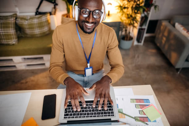 istock Young black entrepreneur working with laptop, office interior 1361085990