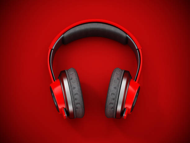 istock Red wireless headphones on dark red background. 3D illustration 1361089420