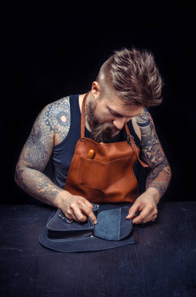 istock Leather Tanner focusing on his work at his workshop 1361089475