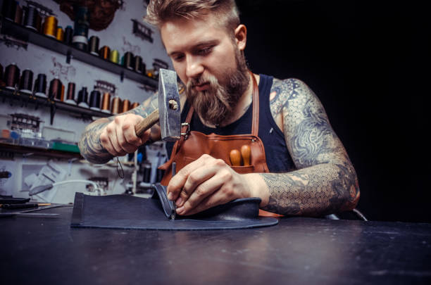 istock Leather workman produces a good product at the workshelf 1361090514