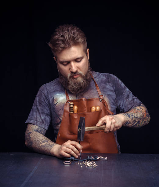 istock Professional Leather Worker works with leather at his leather shop 1361091793