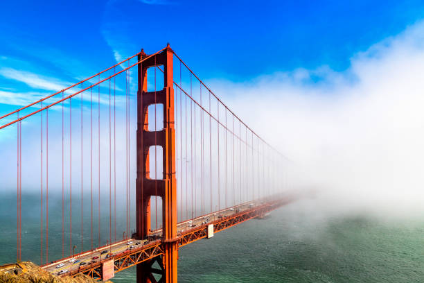 Golden Gate Bridge in San Francisco Golden Gate Bridge surrounded by Fog in San Francisco, California, USA san francisco bay stock pictures, royalty-free photos & images