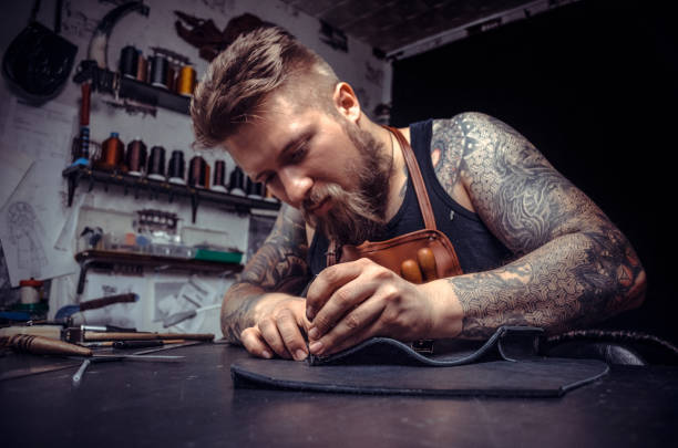 istock Leather cutter creates a new leather product at the tanner shop 1361092178