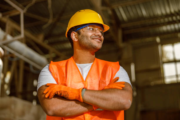 istock Happy African engineer standing at industrial site 1361092429