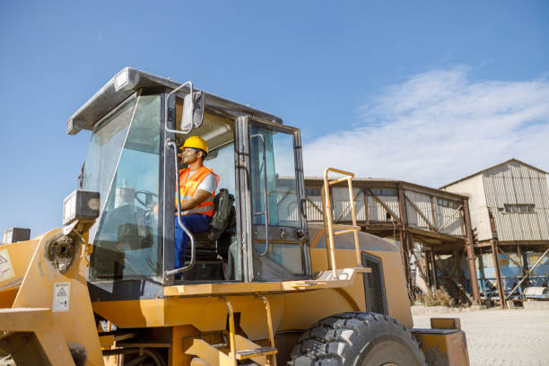 istock Multiracial construction worker using heavy machinery in plant 1361092461