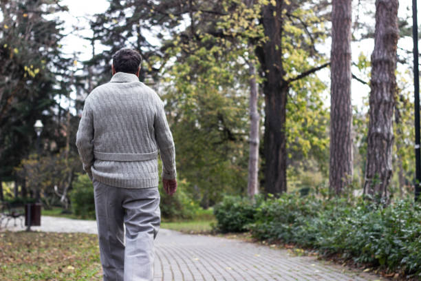 istock Senior man walking and relaxing in park 1361093848