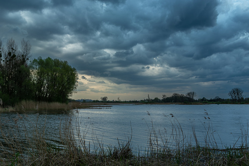 Dark storm clouds over the lake, spring view, Stankow, Poland