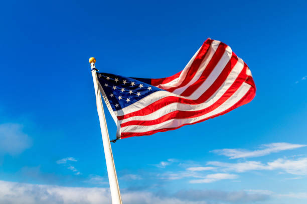 istock USA flag waving against sky 1361098365