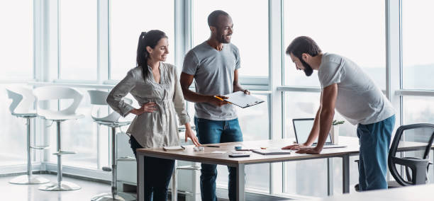 istock Website header of Young professional team discussing business plan in the office 1361099149