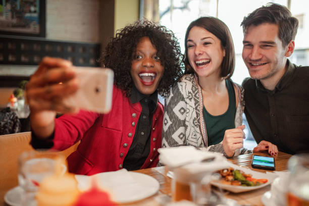 istock Happy group of friends taking selfie while having breakfast in the restaurant 1361099330