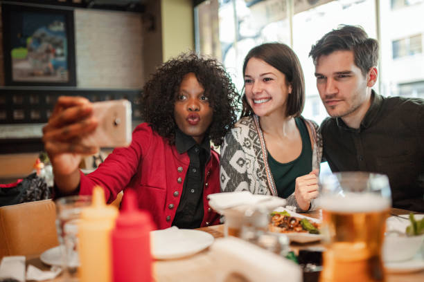 istock Happy group of friends taking selfie while having breakfast in the restaurant 1361099348