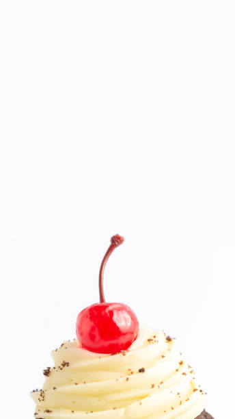 istock Muffin with topping and a cherry on top, isolated over a white background. Vertical banner with copy space. 1361100470