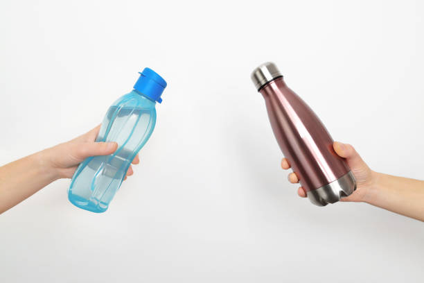 istock Aluminum bottle vs. Plastic bottle. Eco friendly alternative to plastic. Choice between plastic vs steel. 1361101330